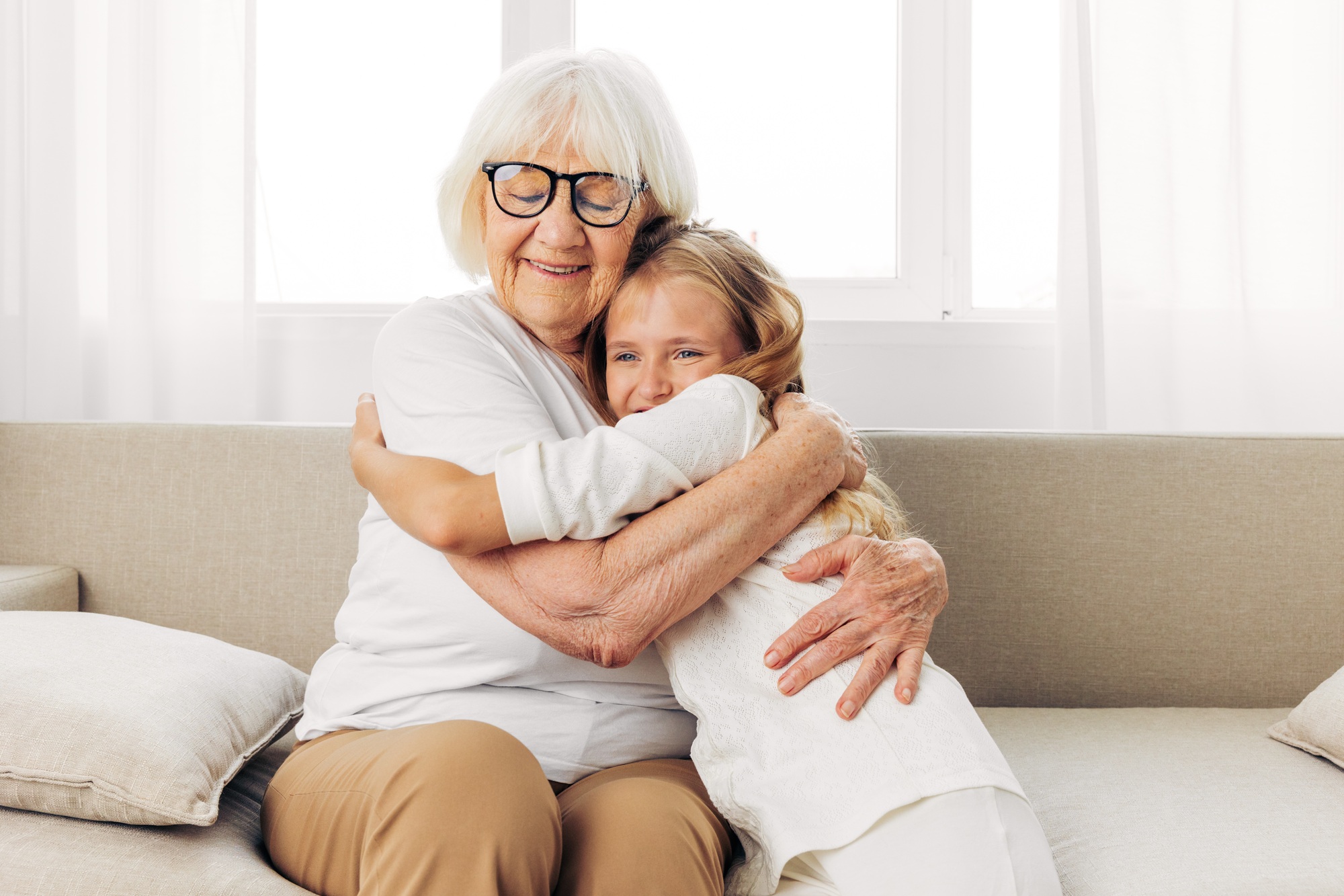 Home woman happy family love child sofa granddaughter grandmother couch girl